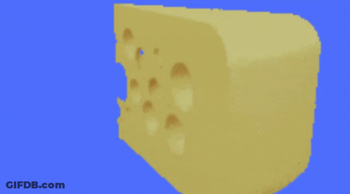 Yellow Teletubbies Carrying Box In Front Of Christmas Tree GIF