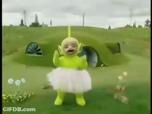Yellow Teletubbies In White Tutu Standing In Field GIF