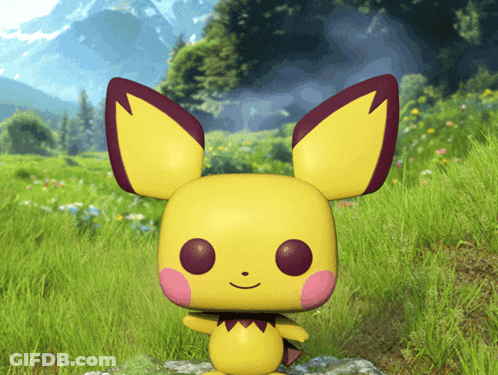 Yellow Toy With Red Ears Standing In Grass GIF