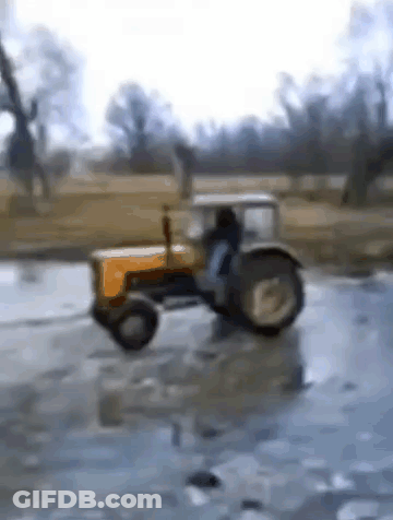 Yellow Tractor Driving Through Icy Puddle GIF