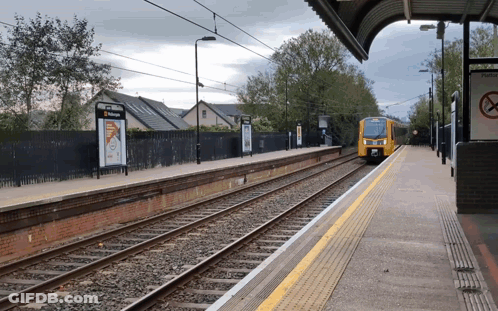Yellow Train Pulling Into Station With No Smoking Sign GIF