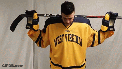 Yellow WV Jersey Man Holding Hockey Stick Overhead GIF