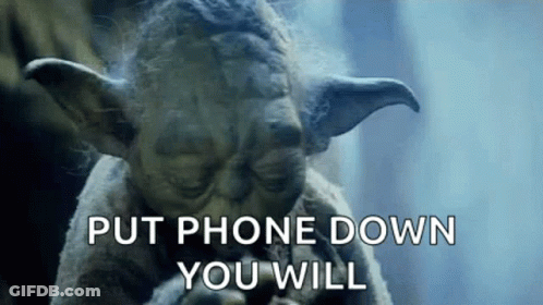 Yoda From Star Wars Is Holding A Cell Phone In His Hand And Says `` Put Phone Down You Will '' . GIF