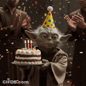 Yoda Is Wearing A Party Hat And Holding A Cake With Candles GIF