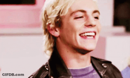 Young Blonde Man In Black Leather Jacket Smiling GIF