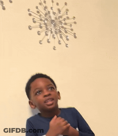 Young Boy At Table With Hands Together GIF