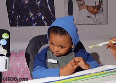 Young Boy Brushing Teeth In Blue Hoodie GIF