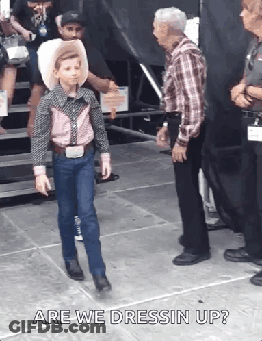 Young Boy Cowboy Walking On Stage With Man Behind GIF