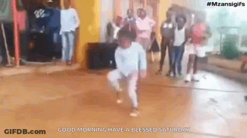 Young Boy Dancing With Group Behind Him GIF