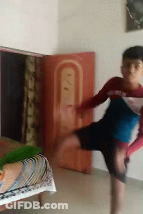 Young Boy Doing Handstand By Red Sign GIF
