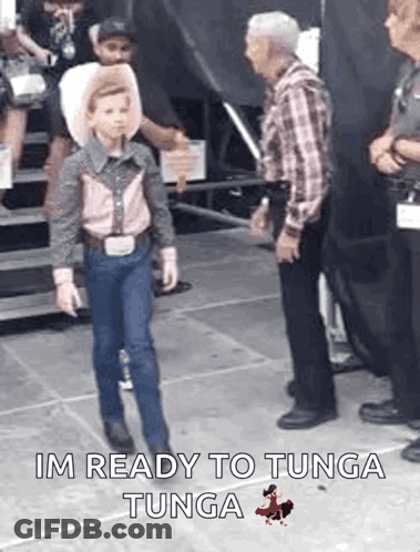 Young Boy Dressed As Cowboy Walking GIF