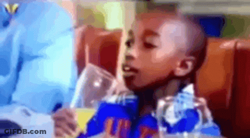 Young Boy Drinking From Glass GIF