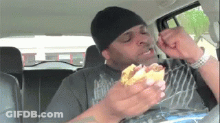 Young Boy Driving Toy Car Down Street GIF