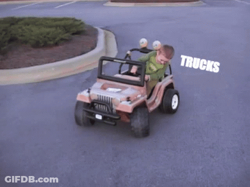 Young Boy Driving Toy Jeep With Trucks GIF
