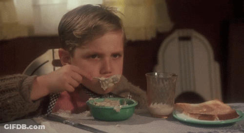 Young Boy Eating Bowl Of Food At Table GIF