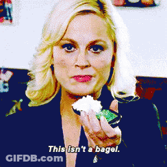 Young Boy Eating Donut With Wow On Shirt GIF