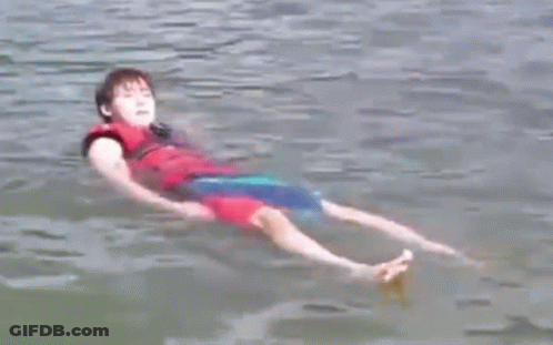 Young Boy Floating On Back In Water GIF
