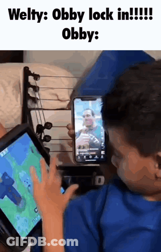 Young Boy Gaming On Tablet Holding Phone GIF