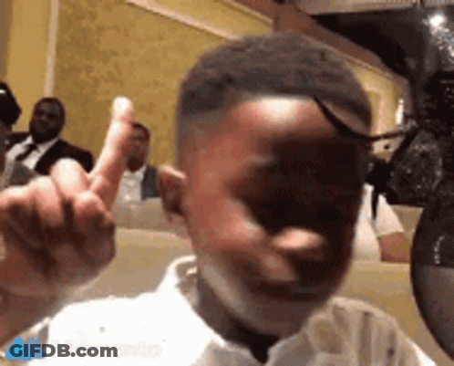 Young Boy Giving Middle Finger At Restaurant GIF