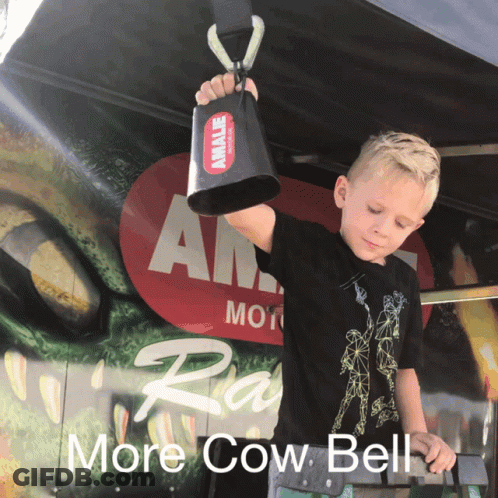 Young Boy Holding Cow Bell In Front Of More Cow Bell Sign GIF