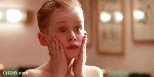 Young Boy Holding Face Looking Surprised GIF