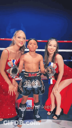 Young Boy Holding Trophy In Boxing Ring GIF