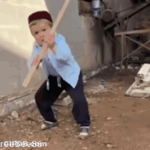 Young Boy Holding Wooden Stick In Mouth GIF