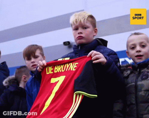 Young Boy Holds Up Red Jersey Number 7 GIF