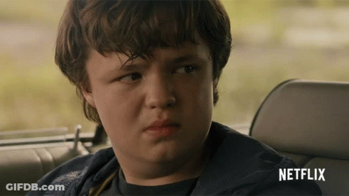 Young Boy In Back Seat Of Car With Netflix Logo GIF