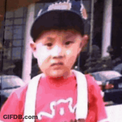 Young Boy In Baseball Cap And Red Shirt With Cat GIF