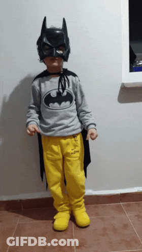 Young Boy In Batman Costume And Black Mask GIF