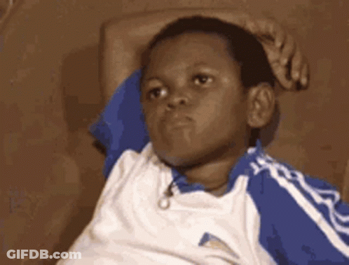 Young Boy In Blue And White Shirt Laying On Couch GIF