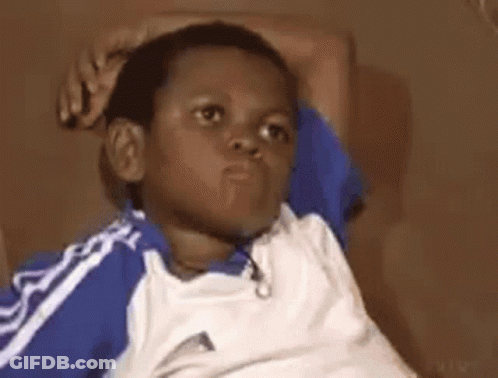 Young Boy In Blue And White Shirt On Couch GIF