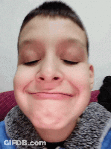 Young Boy In Blue Jacket Making Funny Face GIF