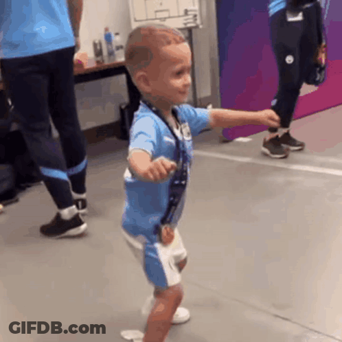 Young Boy In Blue Shirt And Shorts Dancing GIF