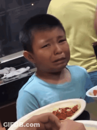 Young Boy In Blue Shirt Crying With Plate Of Food GIF