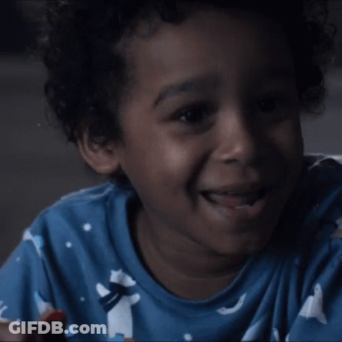 Young Boy In Blue Shirt Laughing Lollipop GIF