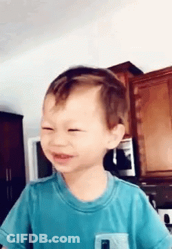 Young Boy In Blue Shirt Making Funny Face GIF