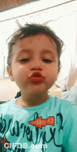 Young Boy In Blue Shirt Making Funny Face GIF