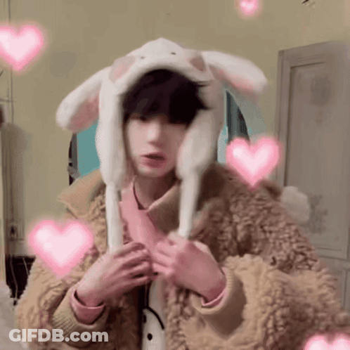 Young Boy In Bunny Hat With Pink Hearts GIF