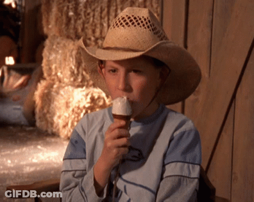 Young Boy In Cowboy Hat Eating Vanilla Ice Cream GIF