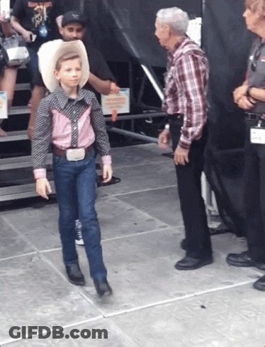 Young Boy In Cowboy Outfit Walking GIF