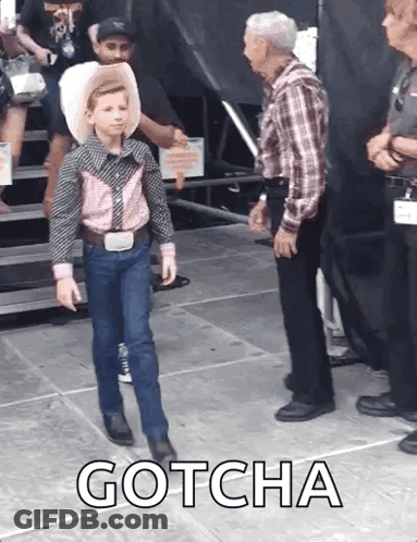 Young Boy In Cowboy Outfit With Older Man And Gotcha Text GIF