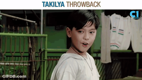 Young Boy In Front Of Green Fence With Takilya Throwback GIF