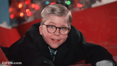 Young Boy In Glasses And Suit Laying On Ground GIF