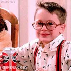 Young Boy In Glasses And Suspenders Holding Pepsi GIF