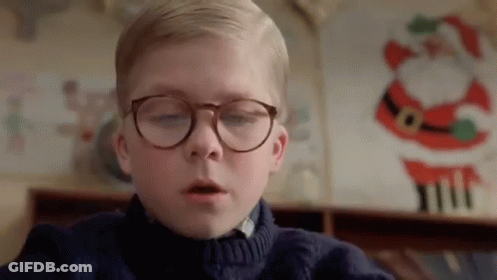 Young Boy In Glasses And Sweater Sitting In Front Of Santa Picture GIF