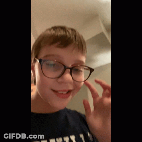 Young Boy In Glasses And T-Shirt Saying First GIF