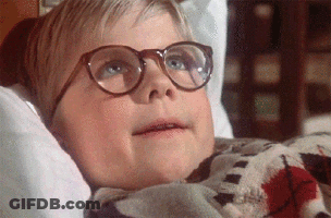 Young Boy In Glasses Laying On Bed GIF