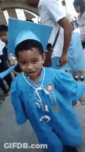 Young Boy In Graduation Cap And Gown GIF